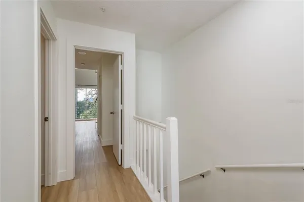 a view of a hallway with wooden floor