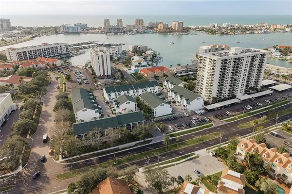 an aerial view of a house with a yard and lake view