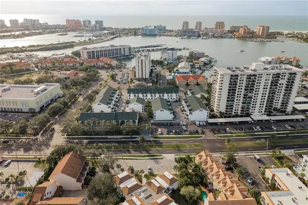 an aerial view of a house with a yard and lake view