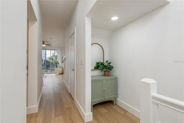 a view of a hallway to a livingroom and furniture