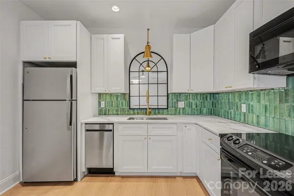 a kitchen with a refrigerator and a stove