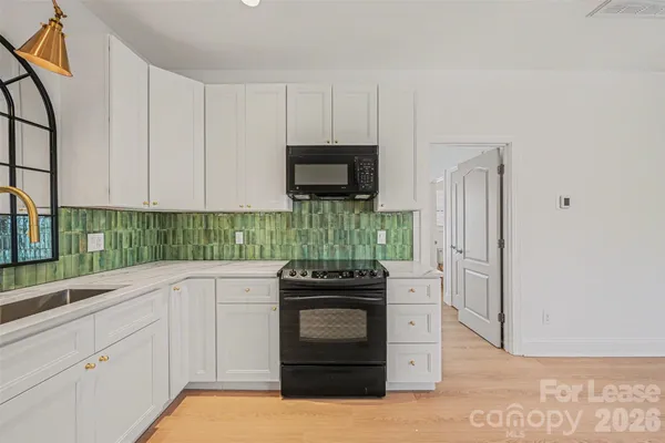 a kitchen with a stove and a refrigerator