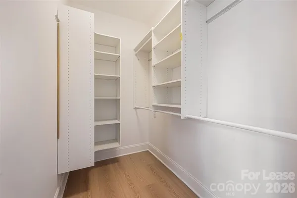 a view of an empty walk in closet with empty racks