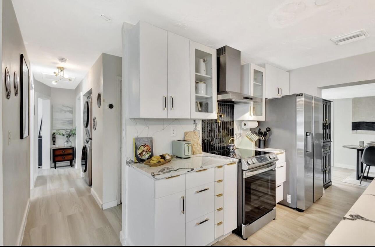 115 West 31st Court Riviera Beach, FL 33404 - Photo 4 of 21 Kitchen With View To Rooms