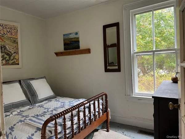 a bedroom with a bed and window