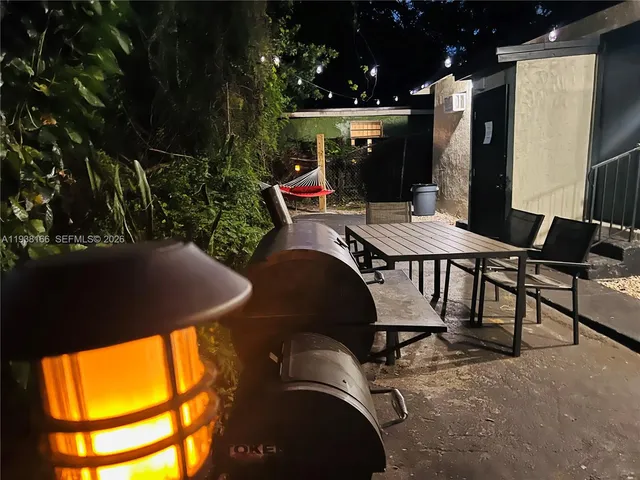 a view of a patio with table and chairs and potted plants