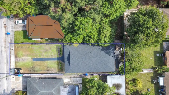 an aerial view of a house with yard