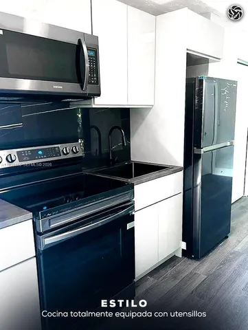 a kitchen with a refrigerator and a microwave