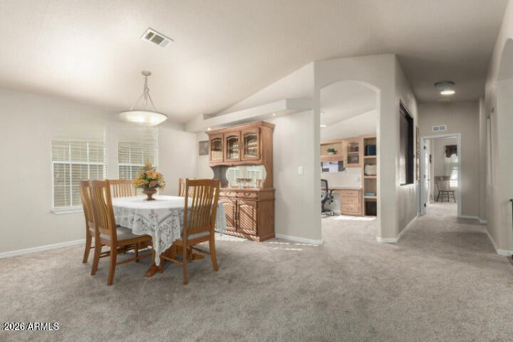 3301 South Goldfield Road, Unit 4086 Apache Junction, AZ 85119 - Photo 4 of 41 a view of a dining room and livingroom with furniture
