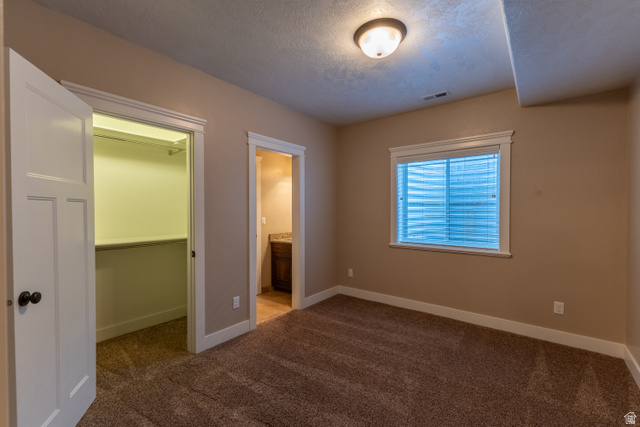 3565 West 1350th Street North Vernal, UT 84078 - Photo 46 of 54 Carpeted room featuring a window with blinds, a ceiling-mounted light fixture, and two doorways