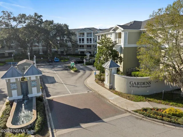 a view of a patio with table and chairs potted plants