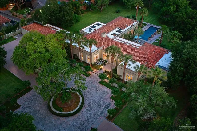 an aerial view of a house with garden space and street view