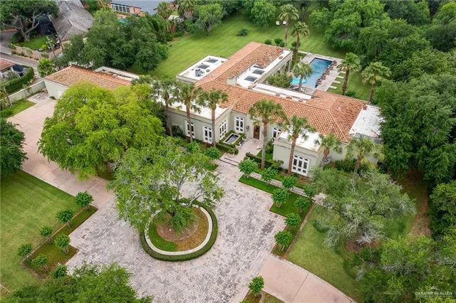 an aerial view of a house with yard swimming pool and outdoor seating