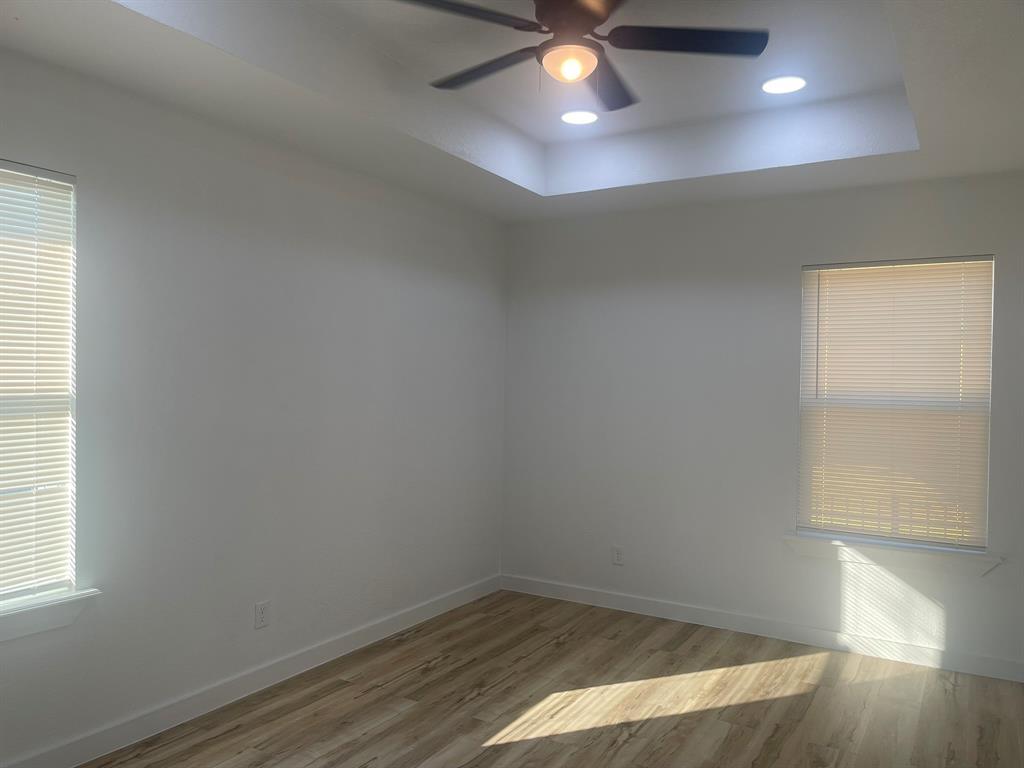 2512 East Overton Road Dallas, TX 75216 - Photo 13 of 21 an empty room with wooden floor and windows