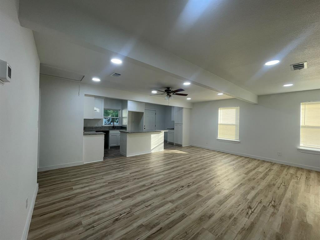2512 East Overton Road Dallas, TX 75216 - Photo 6 of 21 a view of kitchen and empty room with wooden floor