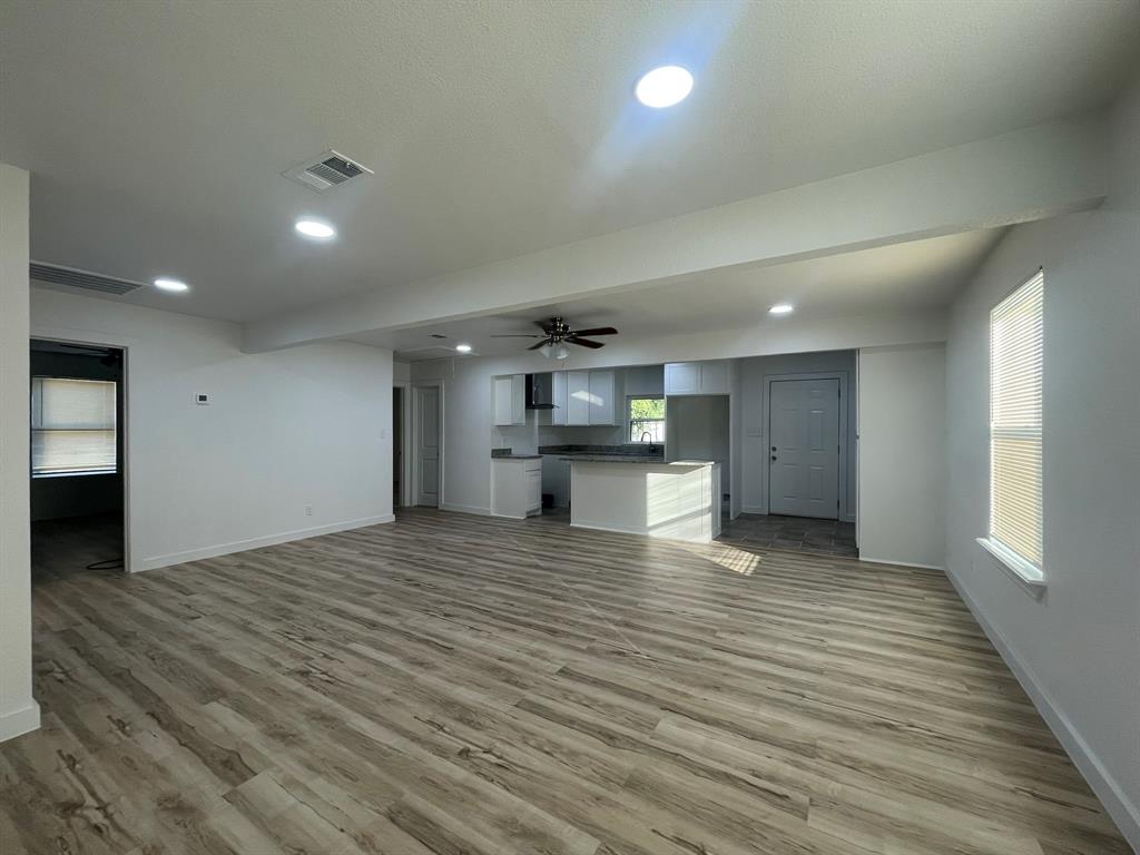2512 East Overton Road Dallas, TX 75216 - Photo 7 of 21 a view of kitchen and a hallway with wooden floor