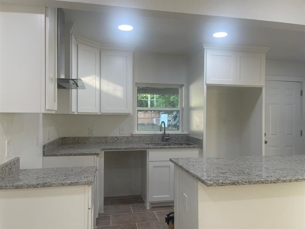 2512 East Overton Road Dallas, TX 75216 - Photo 10 of 21 a kitchen with granite countertop cabinets and window