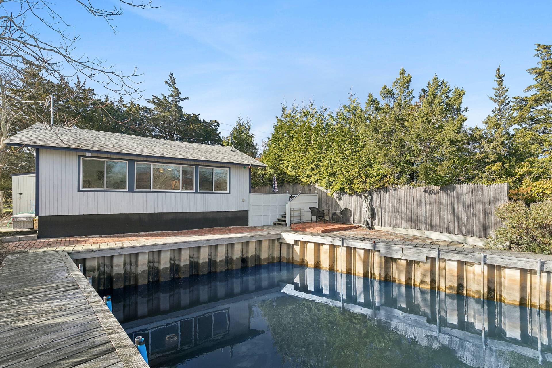 a view of a house with wooden deck and furniture