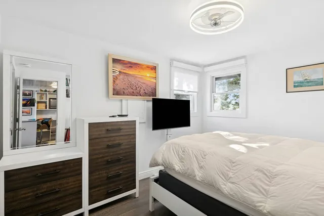 a bedroom with a bed and a flat screen tv