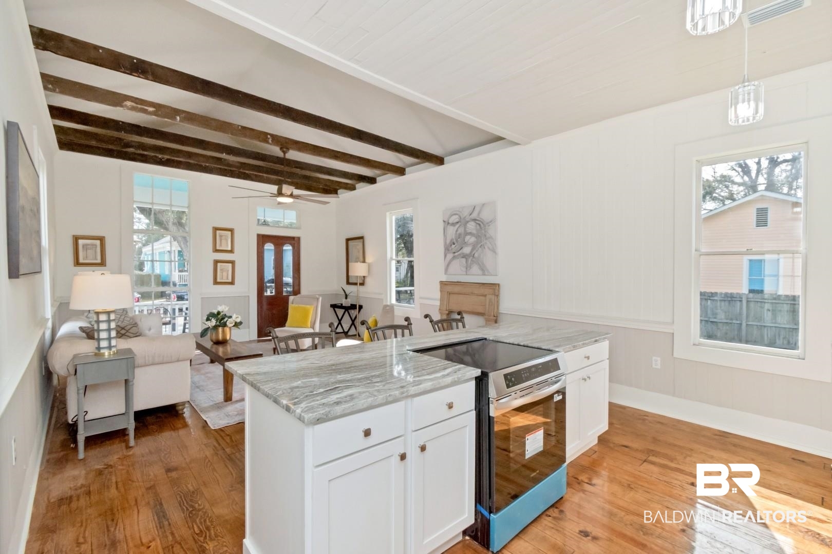 352 Marine Street Mobile, AL 36604 - Photo 20 of 20 Kitchen featuring stainless steel electric stove, light stone counters, open floor plan, white cabinetry, and a wainscoted wall