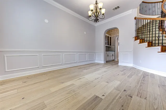 wooden floor with chandelier in empty room