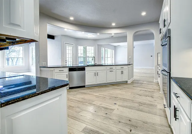 a view of a kitchen with granite countertop cabinets and wooden floor