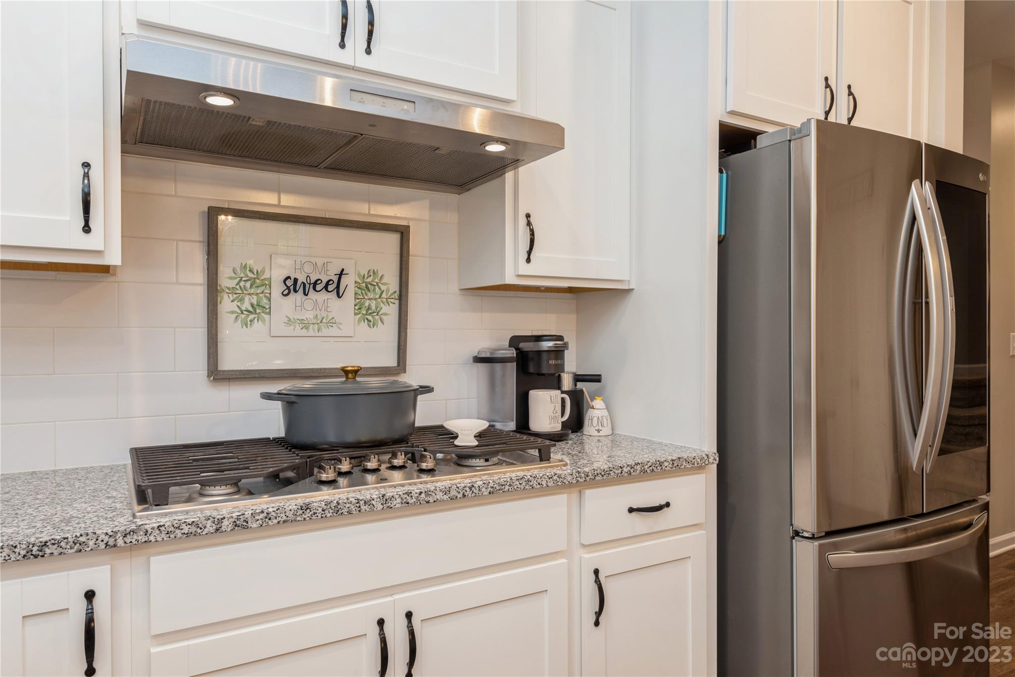 3028 Eagle Ridge Lane Indian Trail, NC 28079 - Photo 12 of 38 a kitchen with granite countertop a refrigerator and a sink