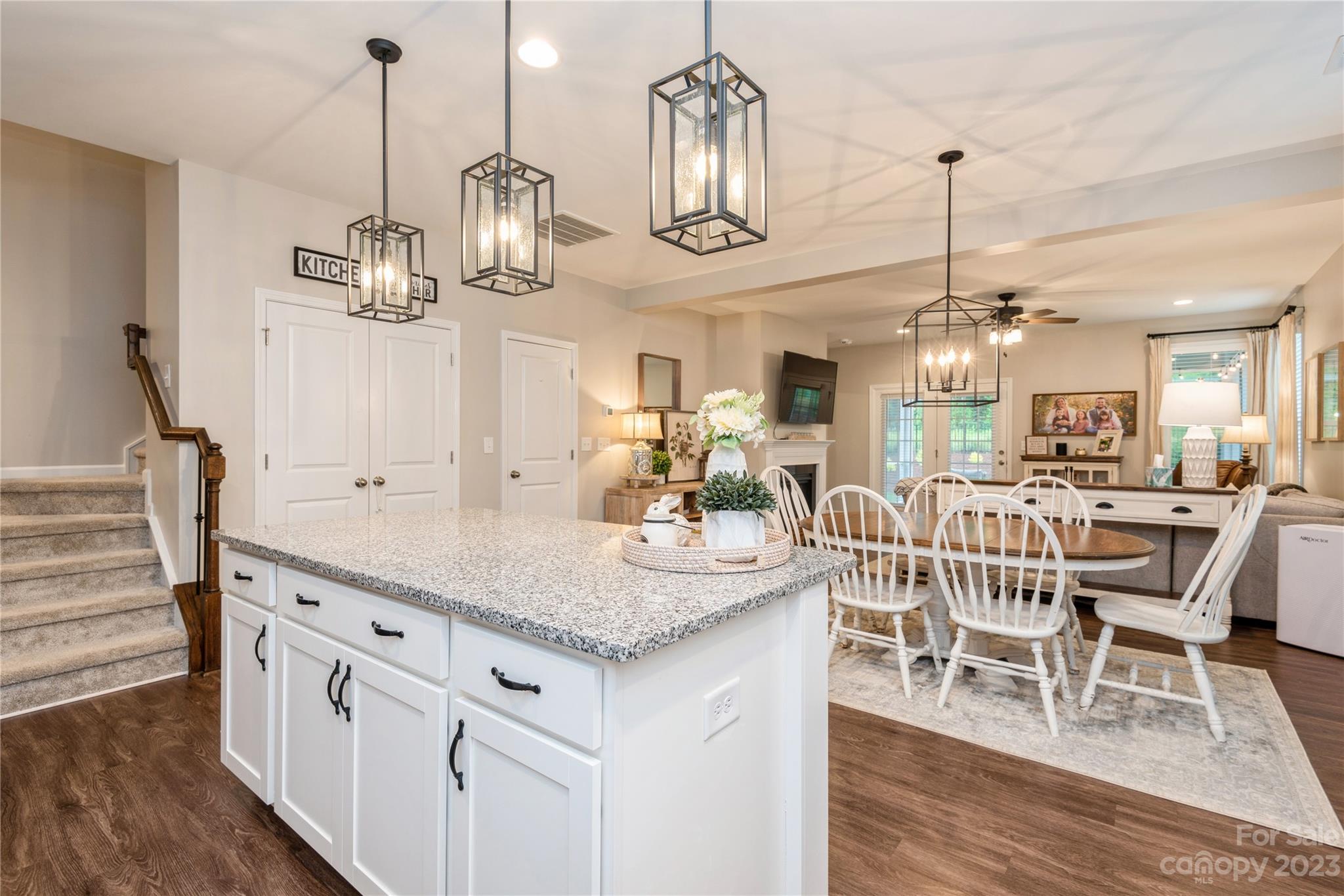 3028 Eagle Ridge Lane Indian Trail, NC 28079 - Photo 13 of 38 a kitchen with stainless steel appliances granite countertop a kitchen island a island a stove a table and chairs