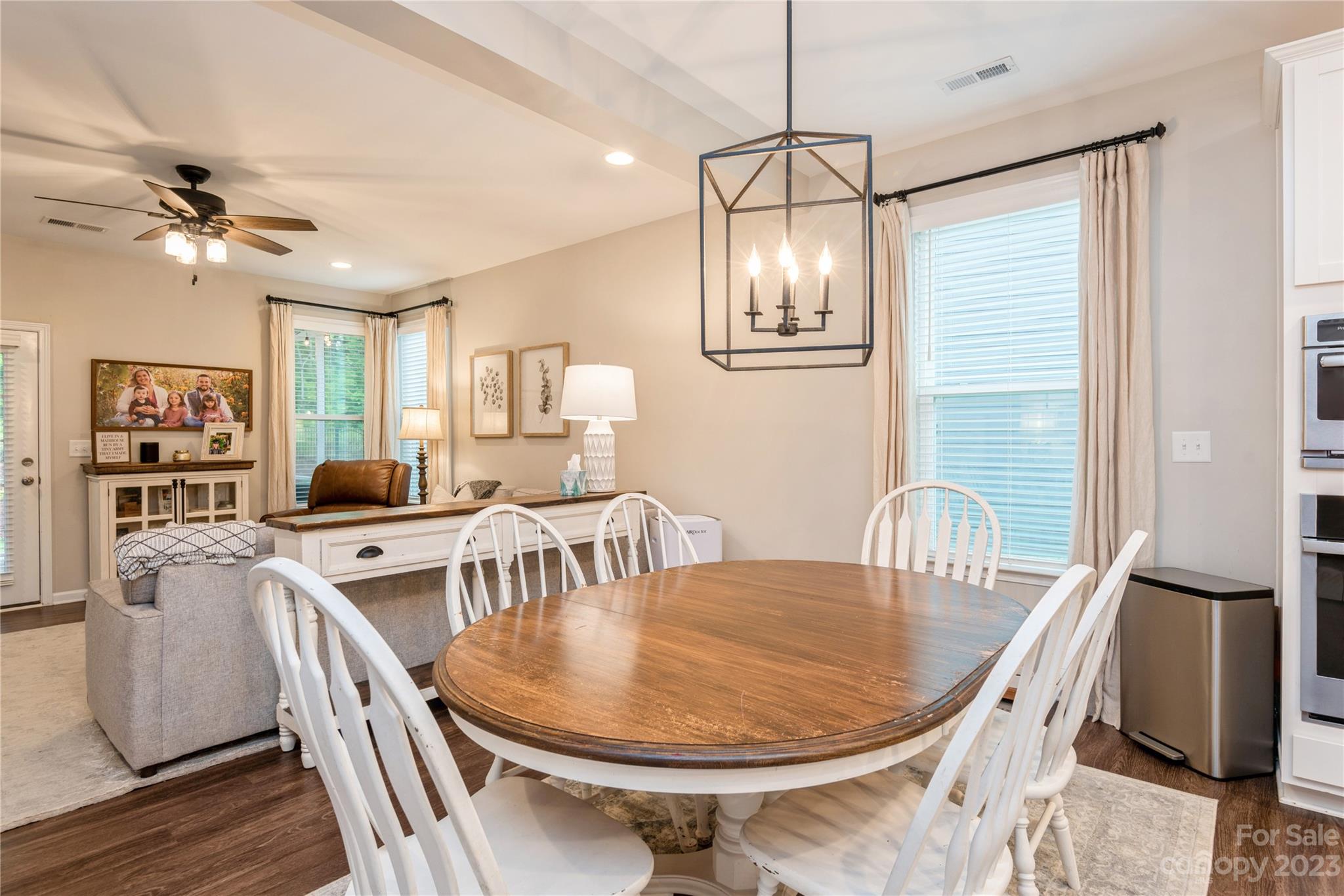 3028 Eagle Ridge Lane Indian Trail, NC 28079 - Photo 14 of 38 a dining room with furniture a chandelier and wooden floor