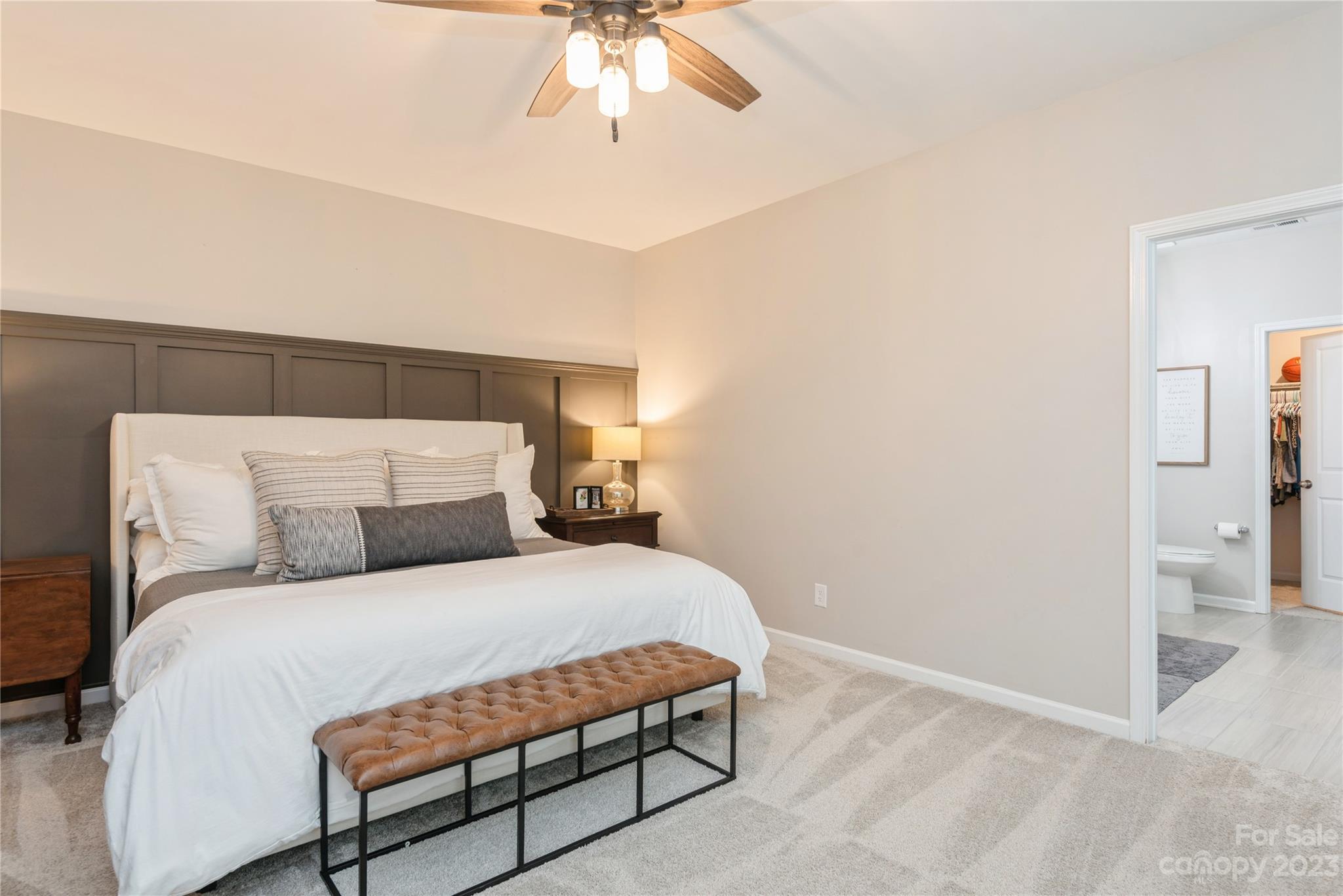 3028 Eagle Ridge Lane Indian Trail, NC 28079 - Photo 20 of 38 a bedroom with a bed and a chandelier