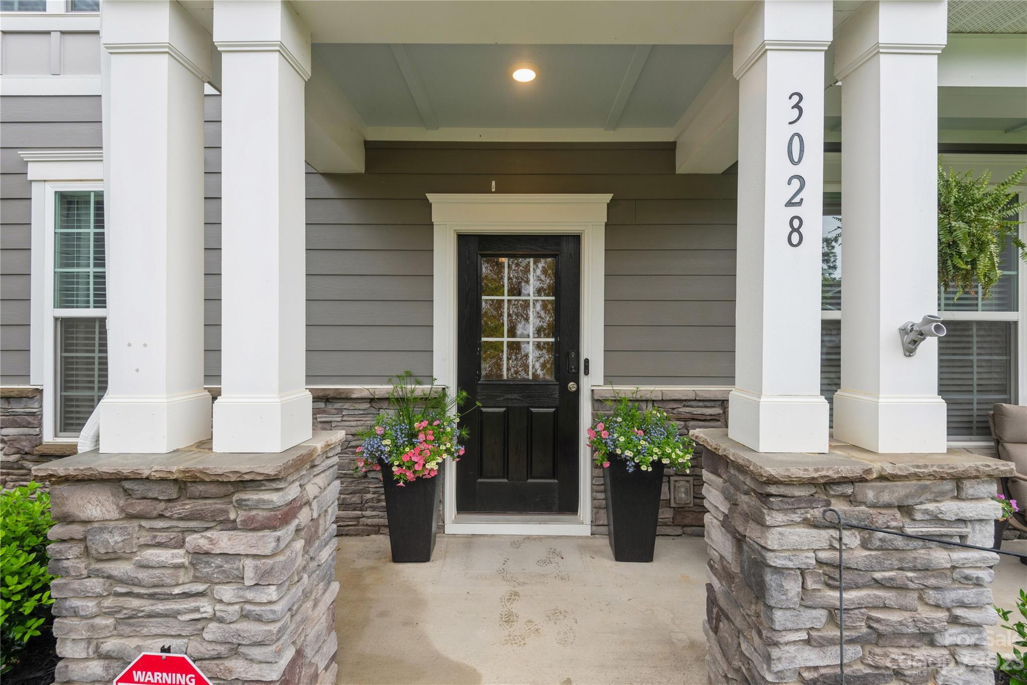 3028 Eagle Ridge Lane Indian Trail, NC 28079 - Photo 2 of 38 a front view of a house with a potted plant
