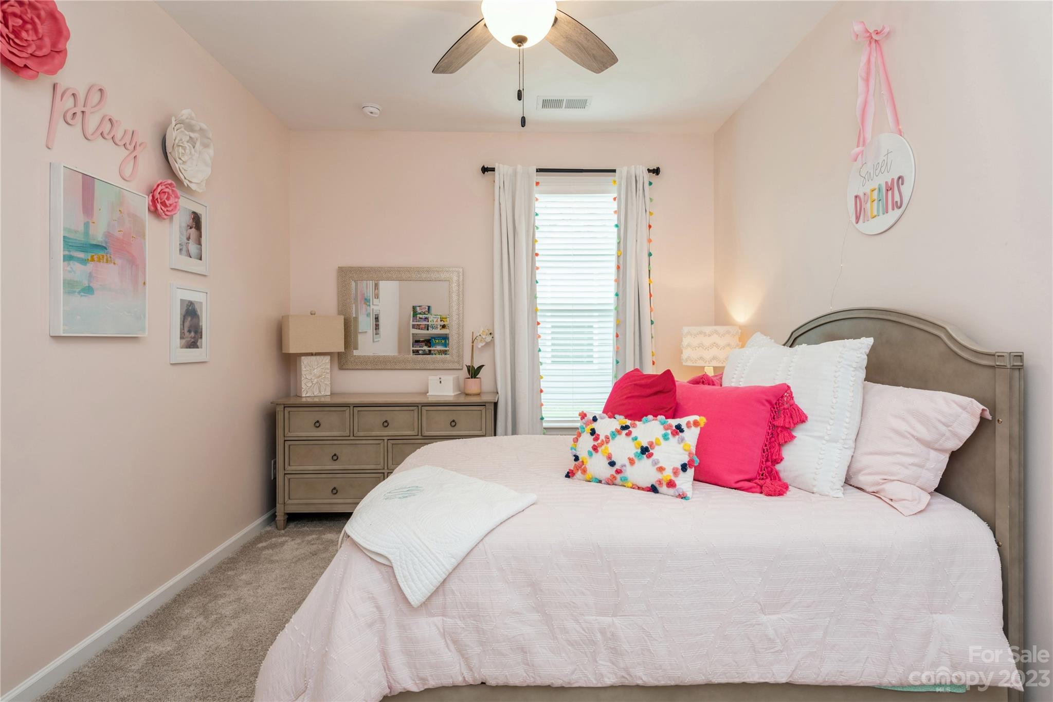 3028 Eagle Ridge Lane Indian Trail, NC 28079 - Photo 24 of 38 a bedroom with a bed and a chandelier
