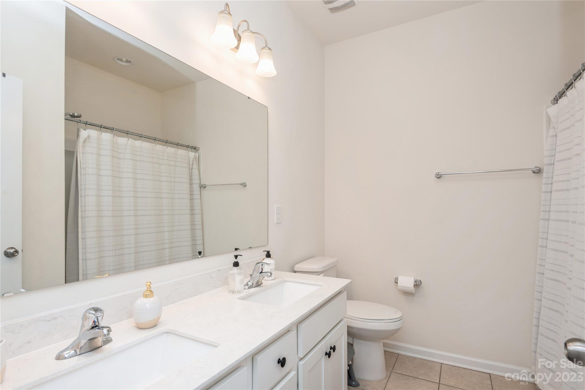 3028 Eagle Ridge Lane Indian Trail, NC 28079 - Photo 25 of 38 a bathroom with a sink a toilet and mirror