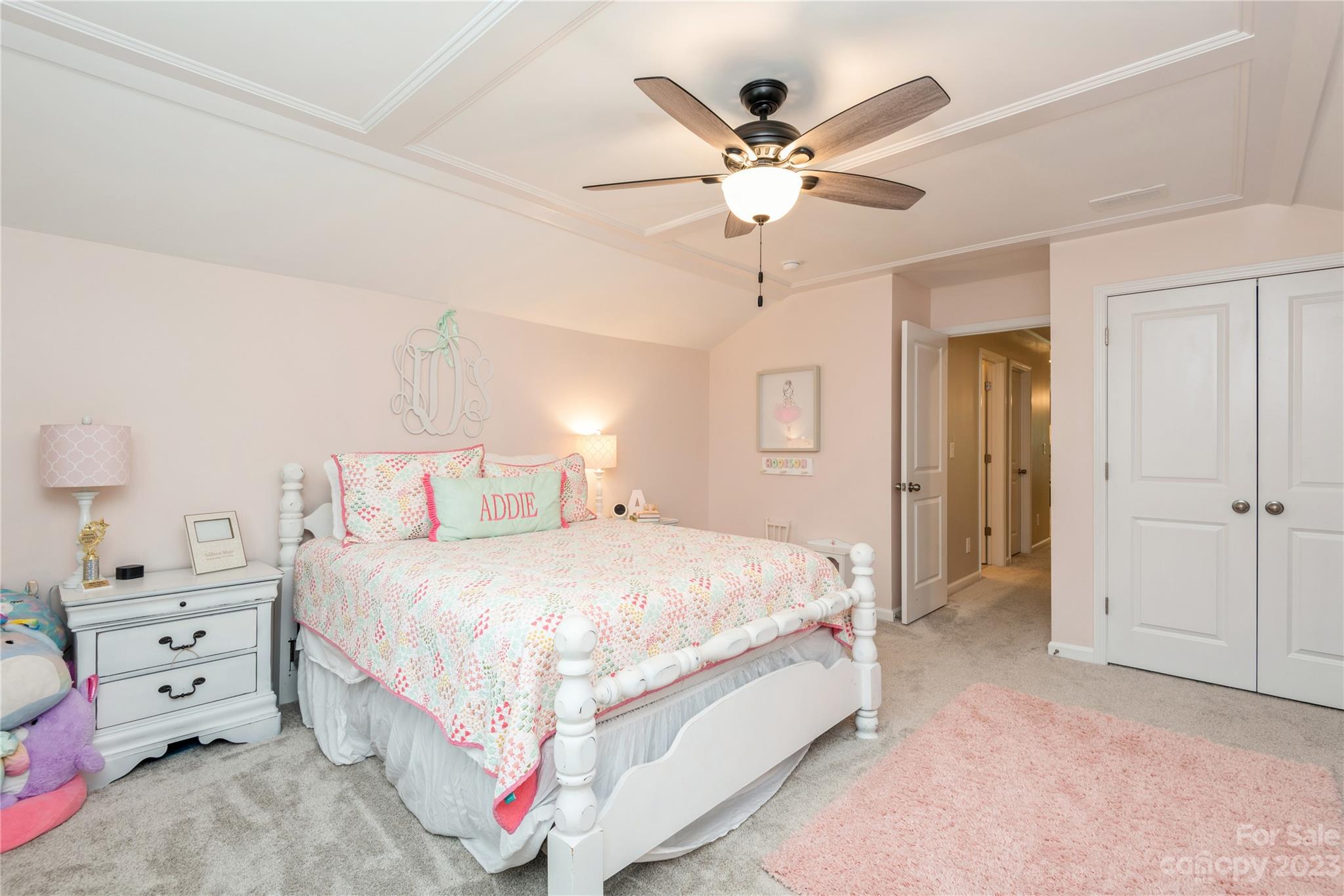 3028 Eagle Ridge Lane Indian Trail, NC 28079 - Photo 30 of 38 a bedroom with a large bed and a chandelier