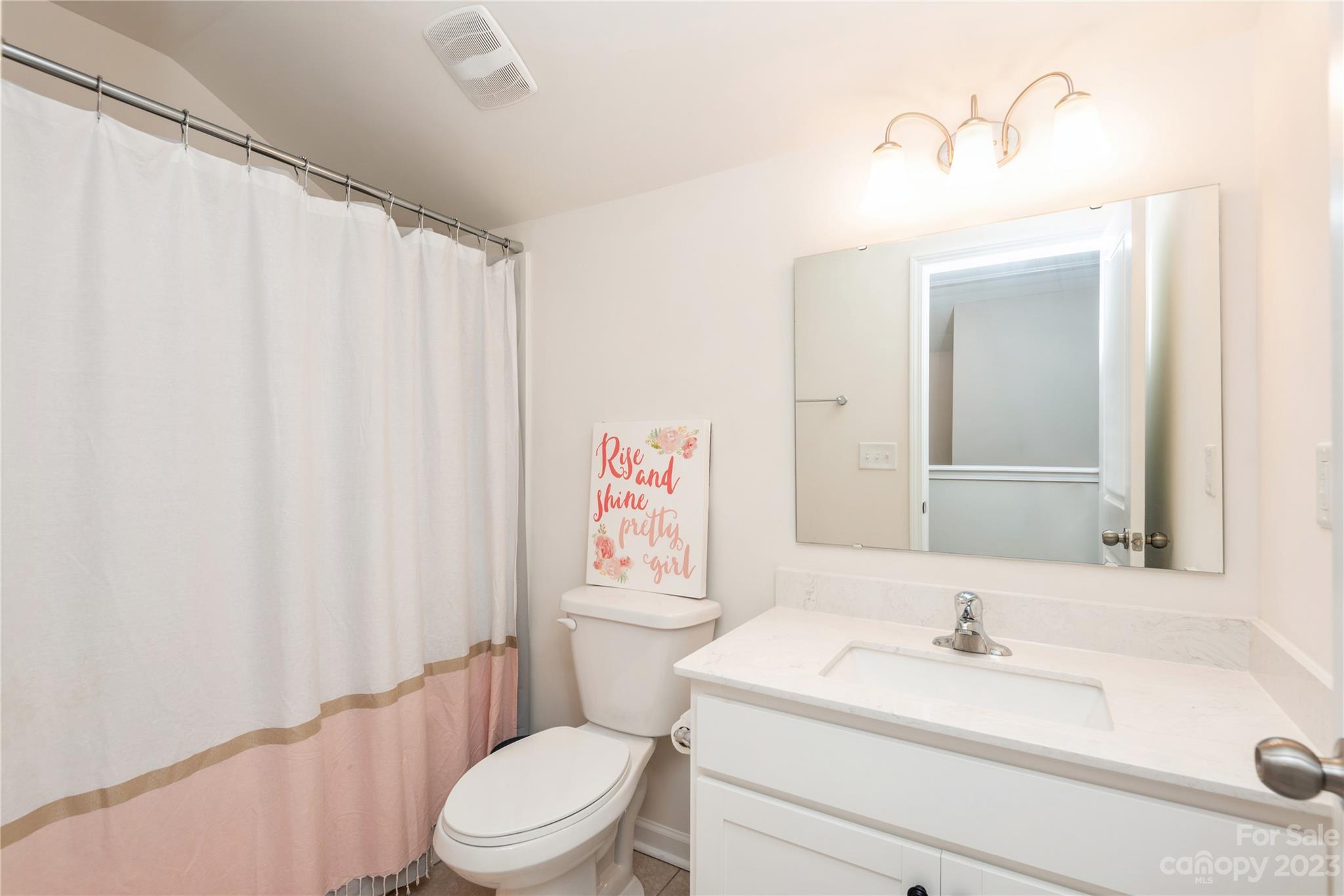 3028 Eagle Ridge Lane Indian Trail, NC 28079 - Photo 31 of 38 a bathroom with a sink a toilet and shower curtain