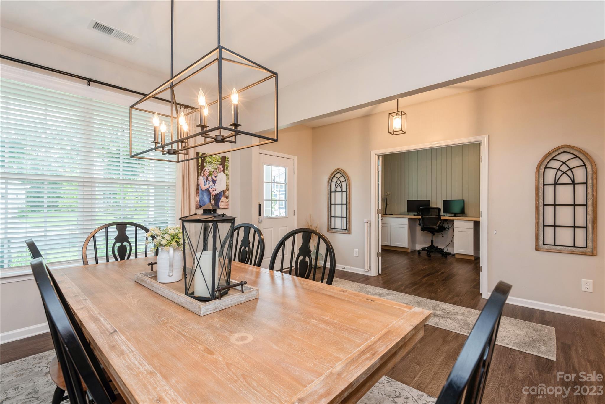 3028 Eagle Ridge Lane Indian Trail, NC 28079 - Photo 5 of 38 a view of a dining room and livingroom with furniture wooden floor a chandelier