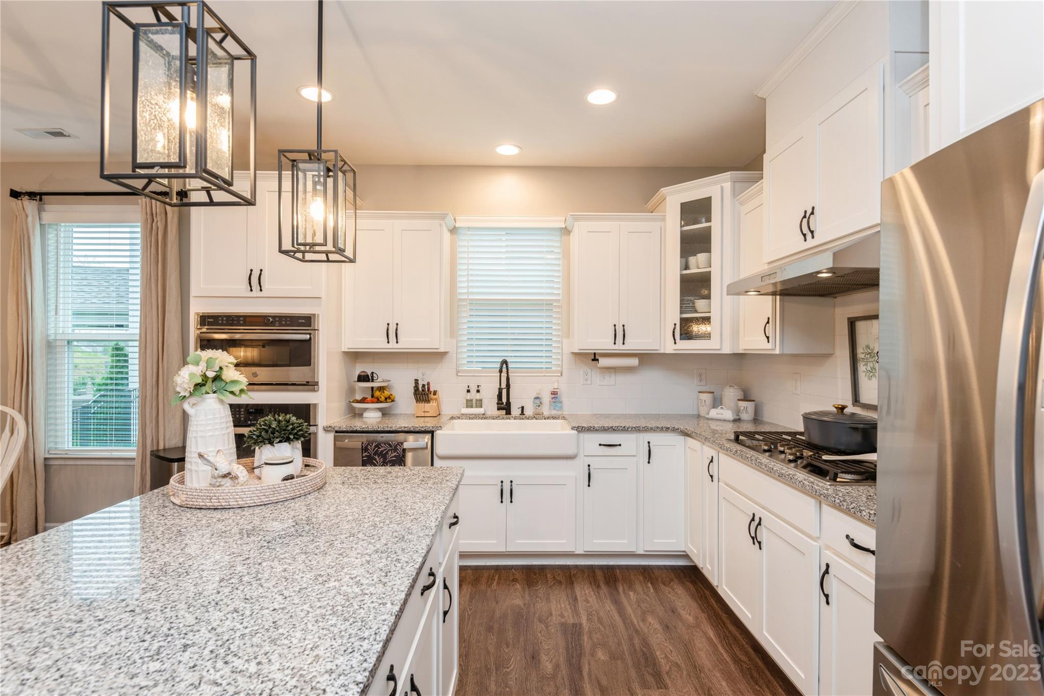 3028 Eagle Ridge Lane Indian Trail, NC 28079 - Photo 9 of 38 a kitchen with stainless steel appliances granite countertop a refrigerator a sink dishwasher a stove and white cabinets with wooden floor