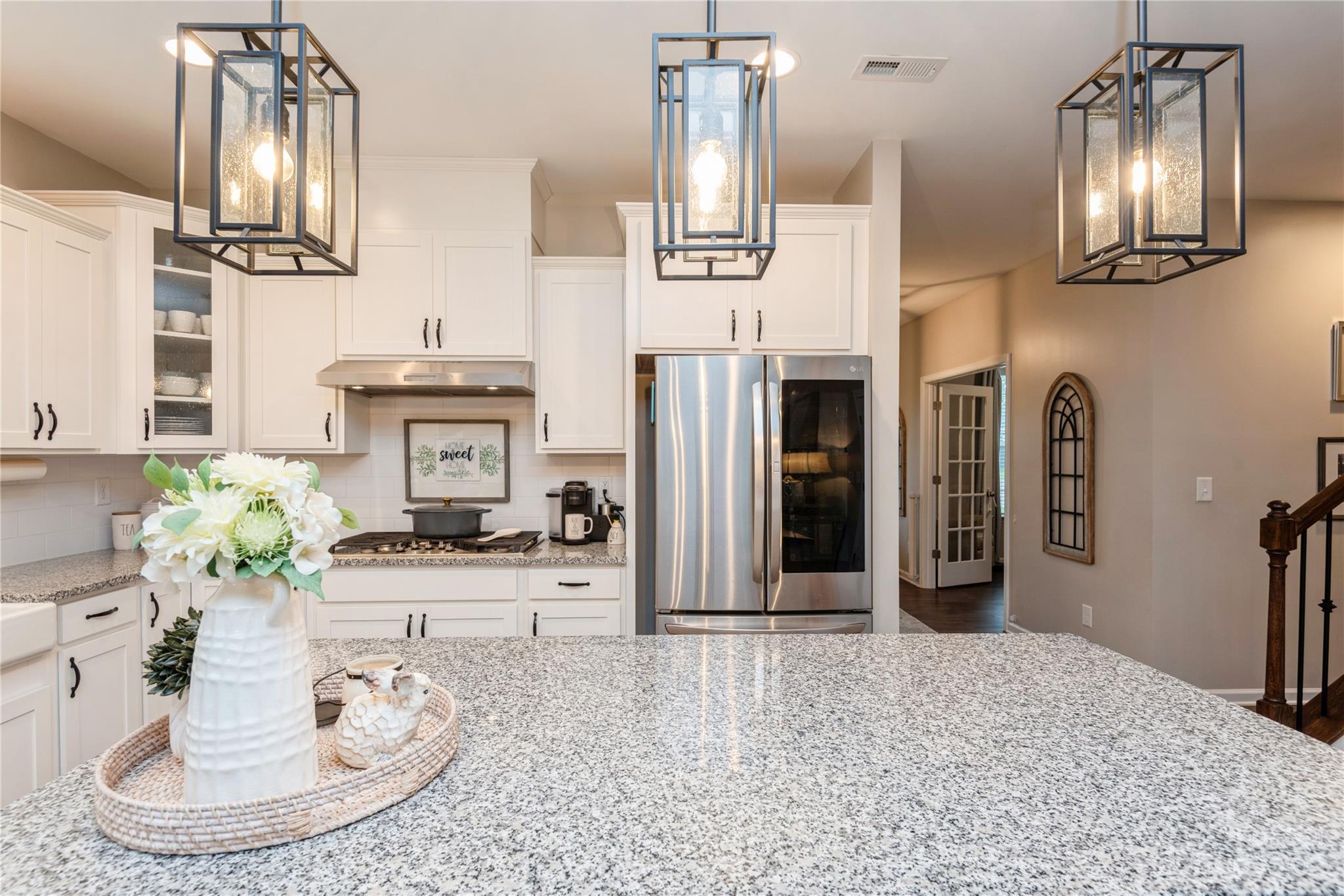 3028 Eagle Ridge Lane Indian Trail, NC 28079 - Photo 10 of 38 a kitchen with stainless steel appliances kitchen island granite countertop a refrigerator a stove and a sink