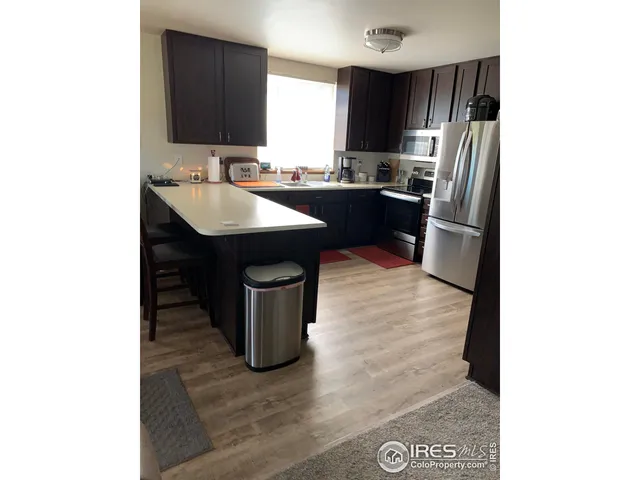 a kitchen with a sink refrigerator and window