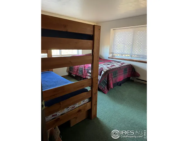 a bed room with a bed and a window