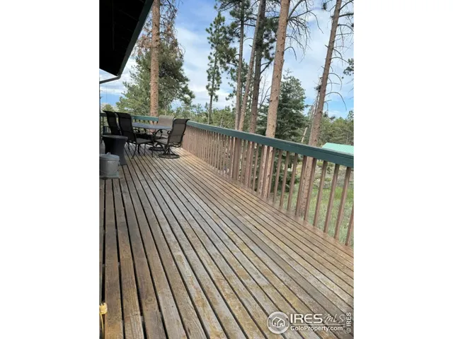 a view of a yard with cars on road