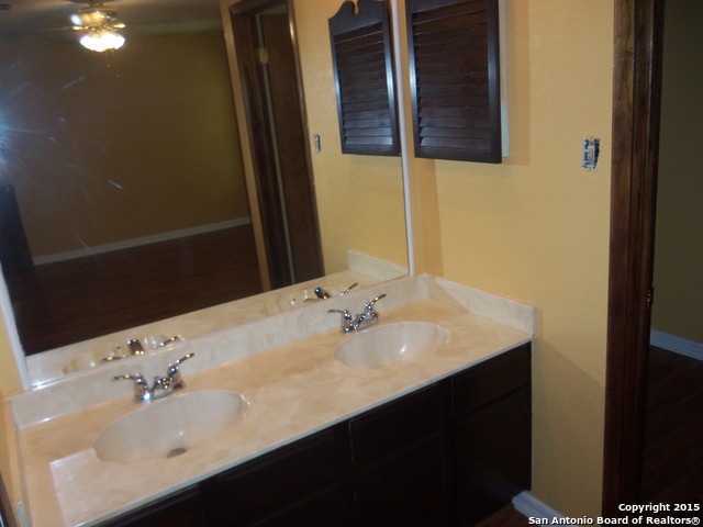 5878 Cliff Path San Antonio, TX 78250 - Photo 11 of 12 a bathroom with a sink and a mirror