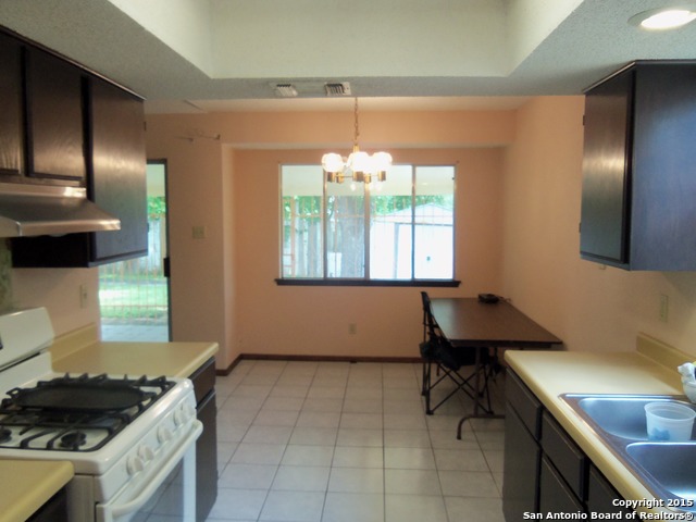 5878 Cliff Path San Antonio, TX 78250 - Photo 3 of 12 a kitchen with a sink cabinets and window