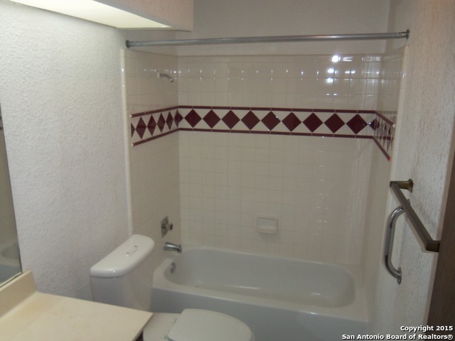 5878 Cliff Path San Antonio, TX 78250 - Photo 6 of 12 a bathroom with a shower a toilet and a sink