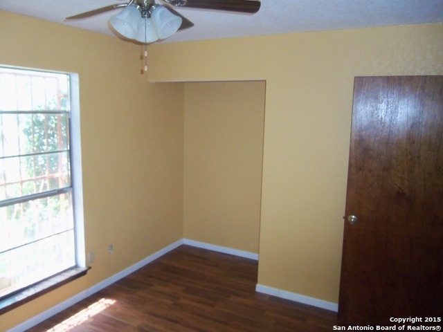 5878 Cliff Path San Antonio, TX 78250 - Photo 7 of 12 a view of an empty room with wooden floor and a window