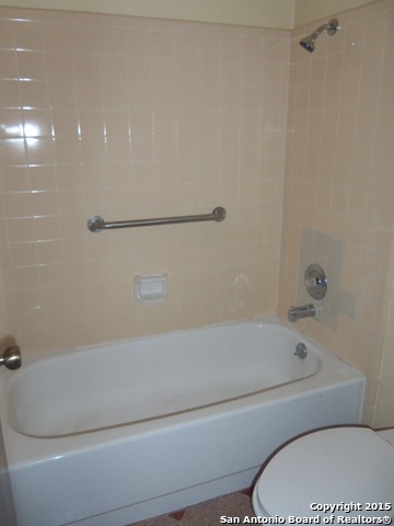 5878 Cliff Path San Antonio, TX 78250 - Photo 10 of 12 a bathroom with a toilet and a bathtub