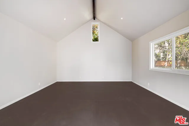 an empty room with windows and entrance