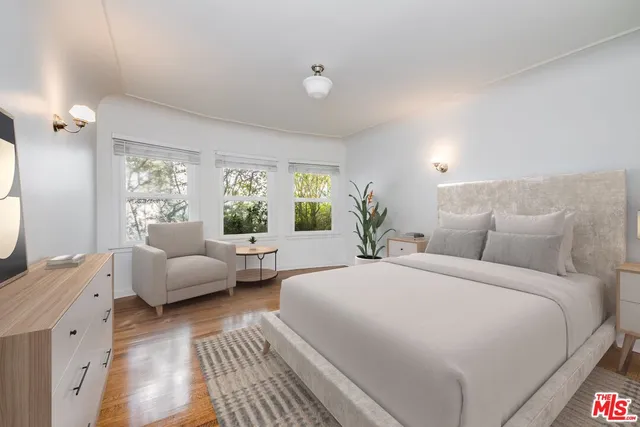 a spacious bedroom with a large bed and a couch