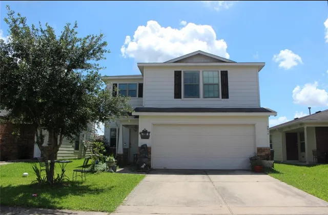 a front view of a house with a garden and plants