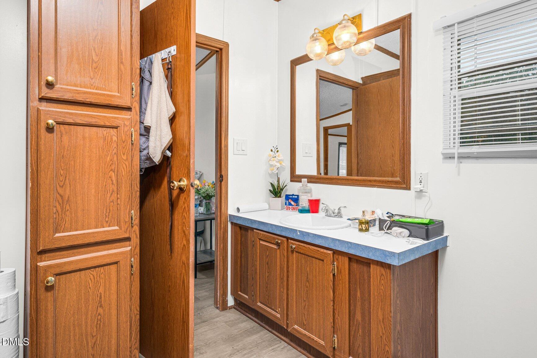 1835 Cokey Road Rocky Mount, NC 27801 - Photo 15 of 42 a bathroom with a sink vanity and a mirror